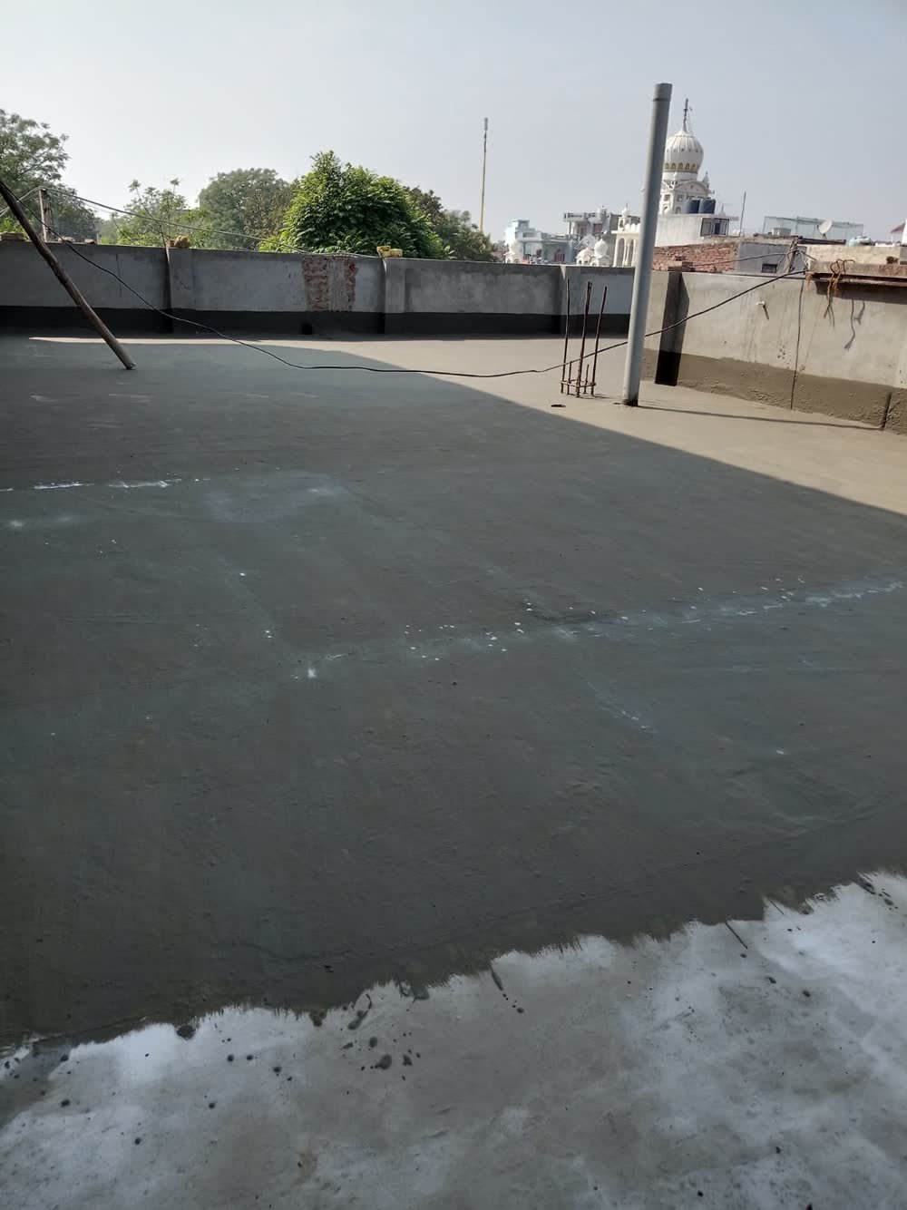 Intermediate polymer chemical waterproofing coat on residential terrace in Panchkula